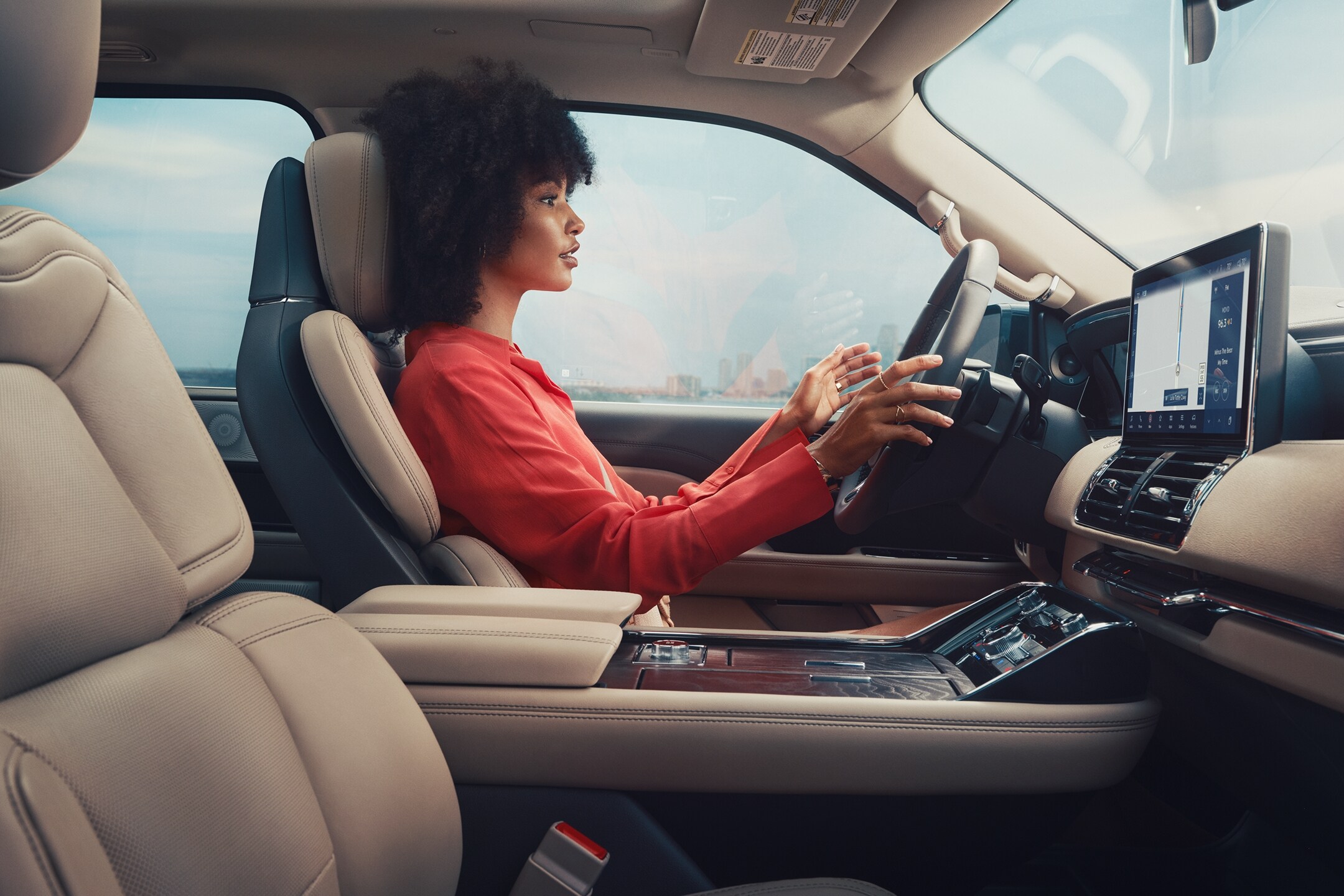 A woman sitting inside the Lincoln Navigator using the BlueCruise feature.