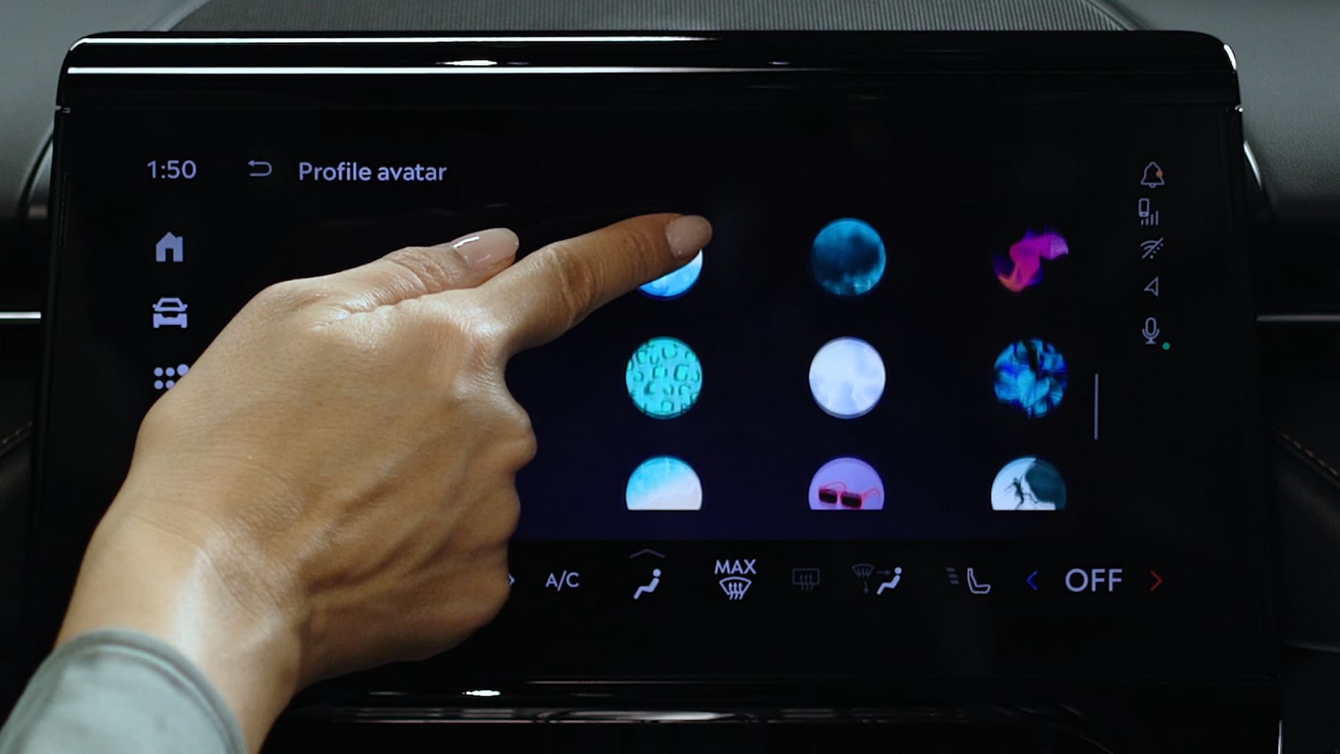 A woman's hand is touching the center-stack display of a Lincoln vehicle.