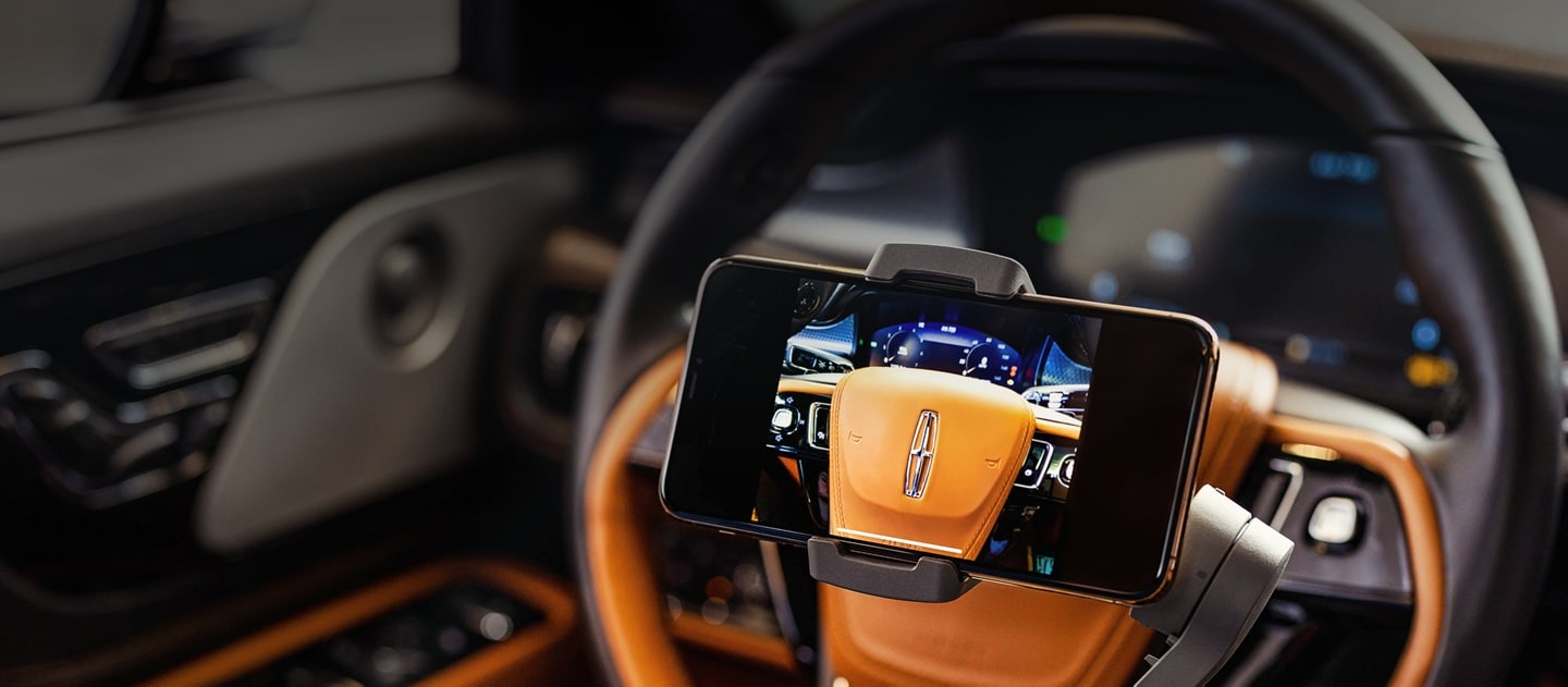 A mobile phone is shown being used to give a private remote showing of a 2024 Lincoln Aviator® Black Label vehicle