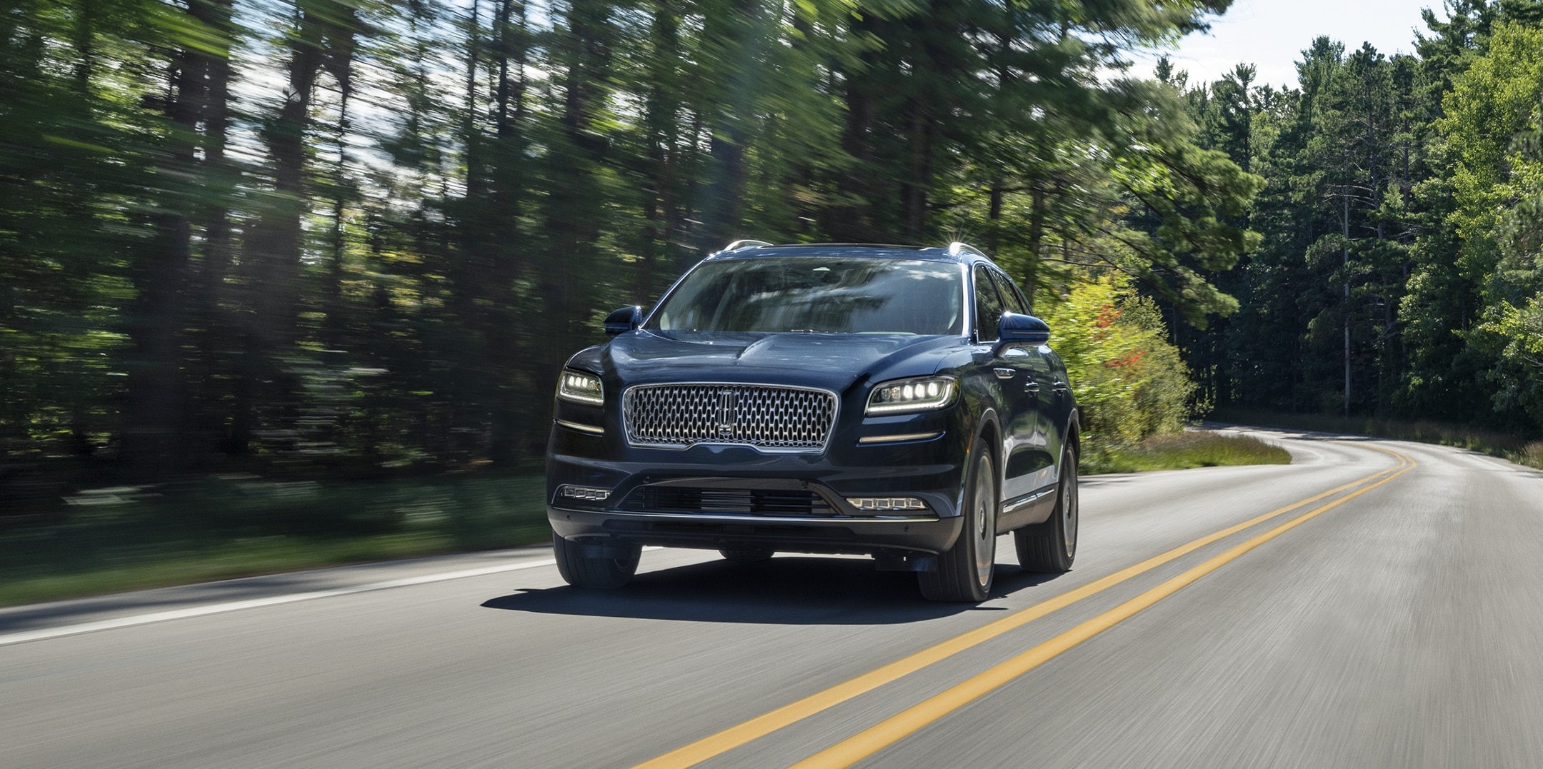 The 2023 Lincoln Nautilus driving down a road.