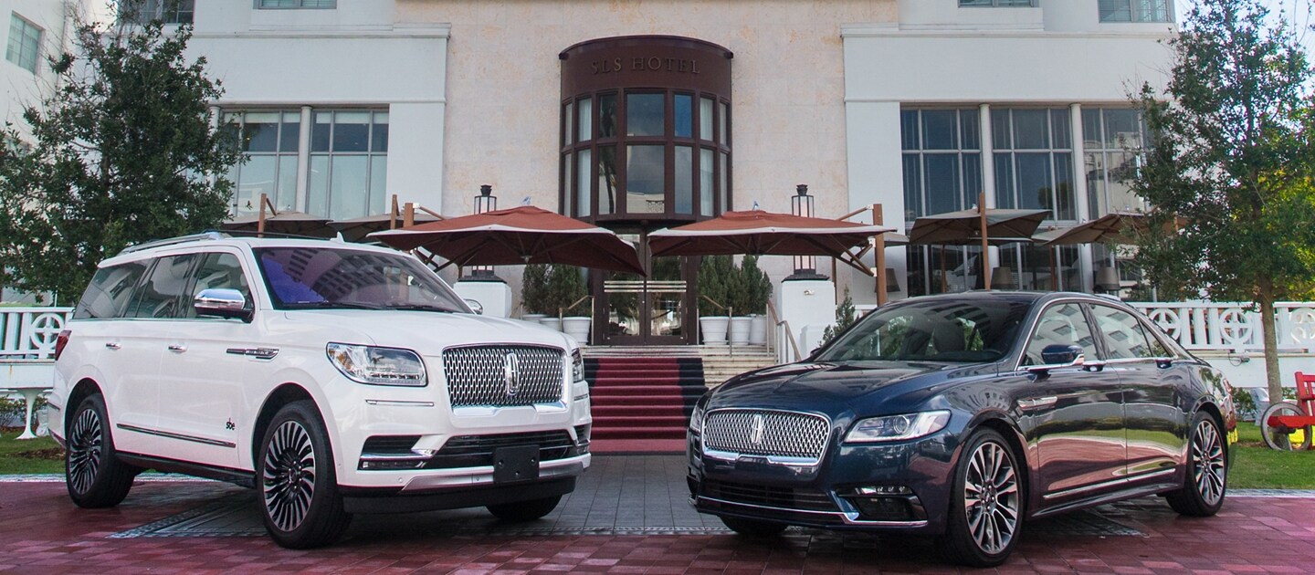 Lincoln vehicles shown in front of hotel