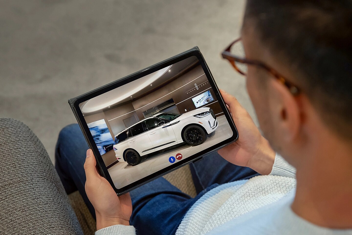 A person is shown taking a live virtual tour of a 2025 Lincoln Aviator® SUV on an tablet device.