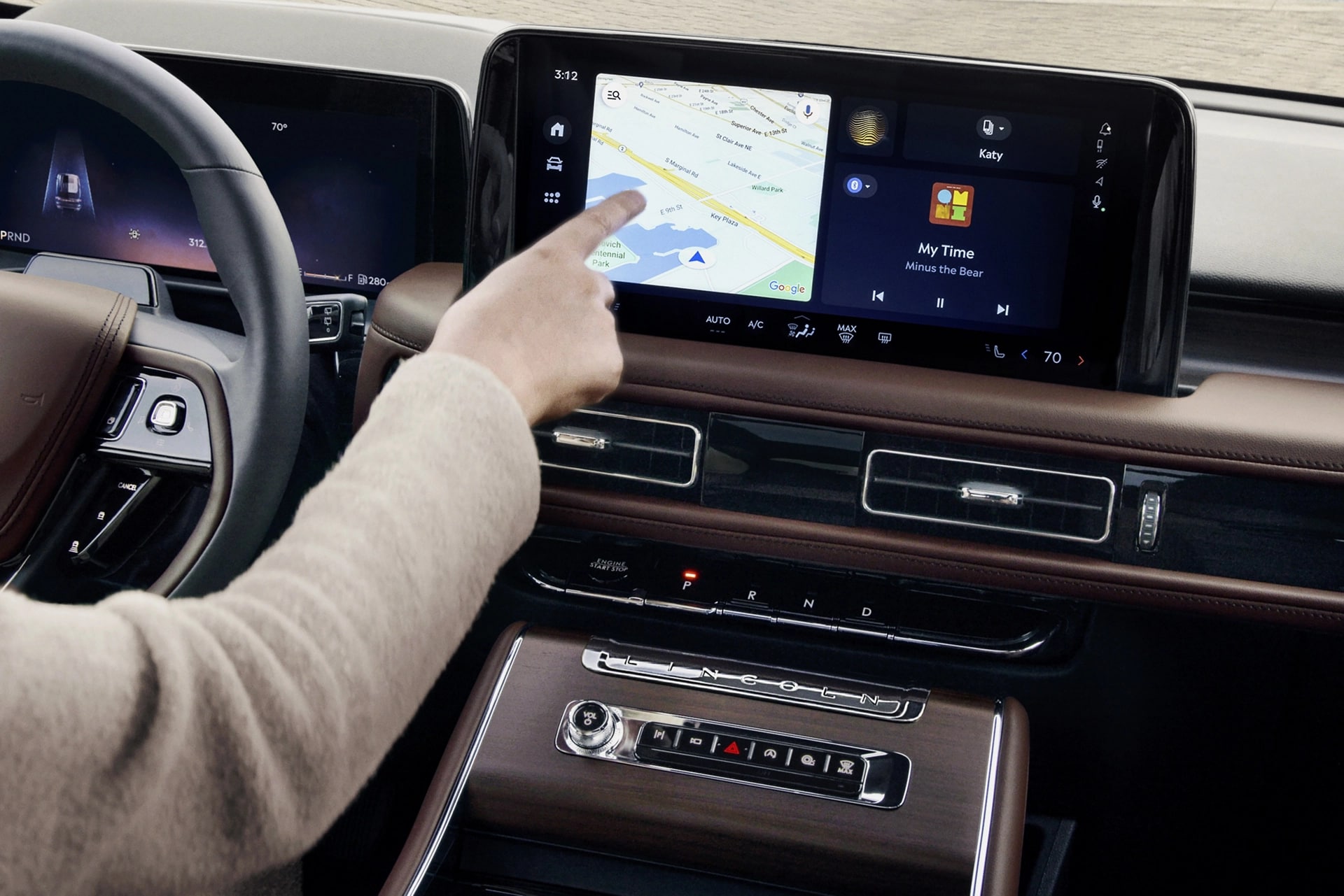 The driver of a 2025 Lincoln Aviator® SUV touches the center touchscreen