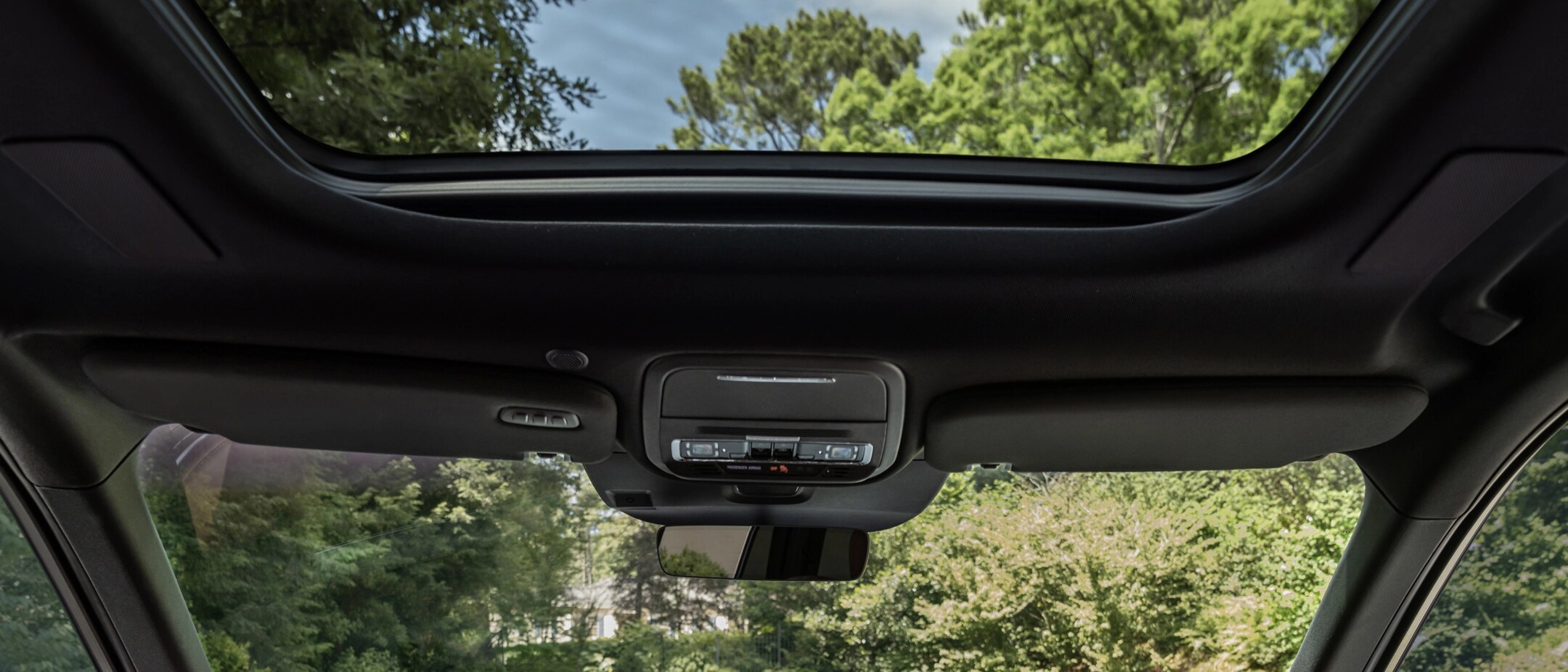 A smiling couple sitting in the 2025 Lincoln Aviator.