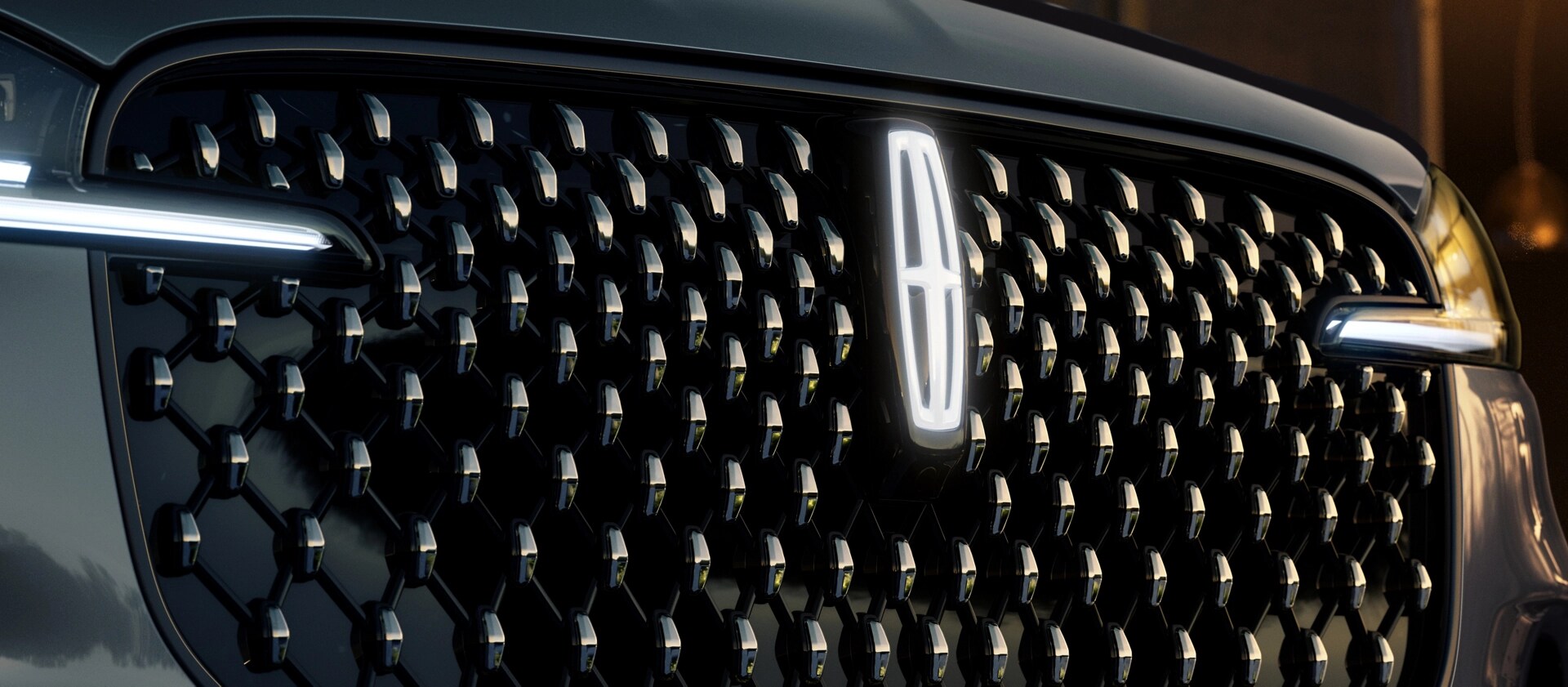 The grille of 2025 Lincoln Black Label Aviator® SUV with glowing Lincoln Star logo in the center