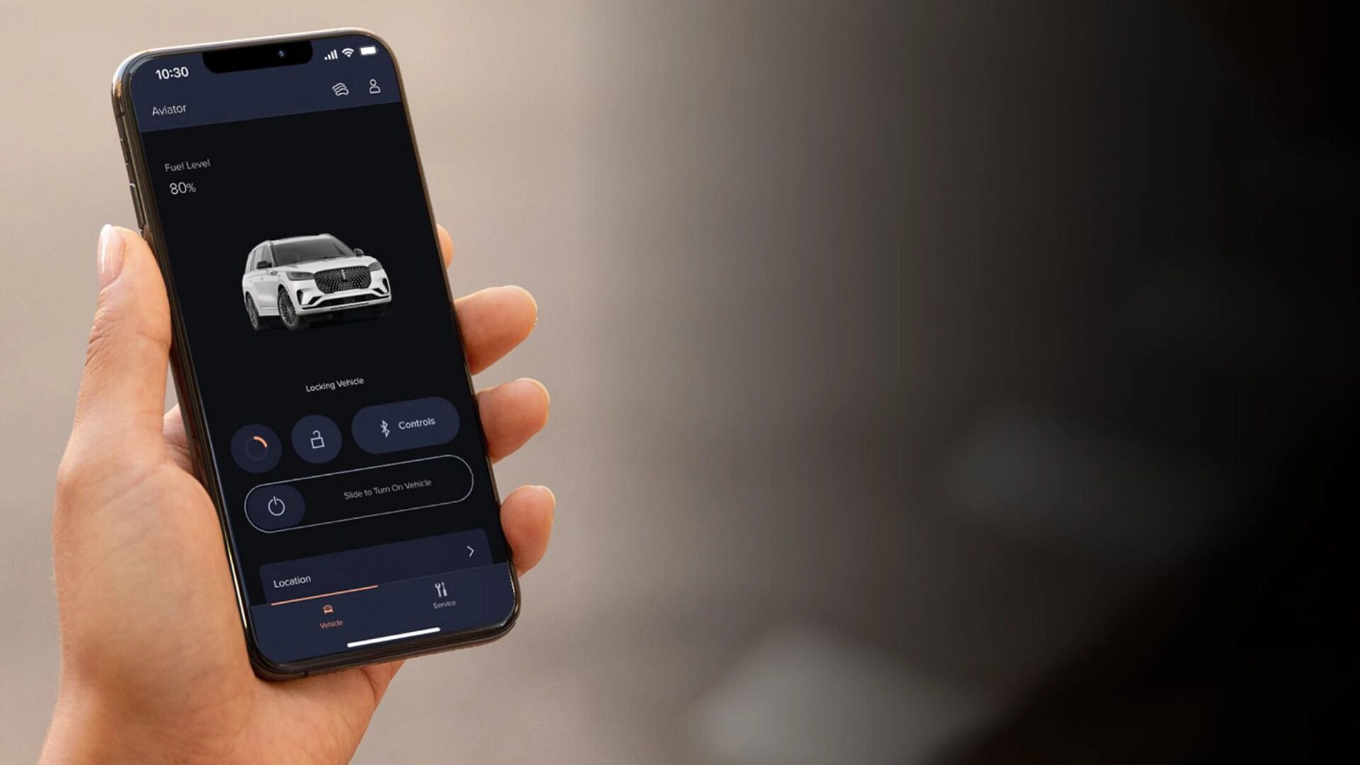 A hand holding a phone and on it is the Lincoln Way app.