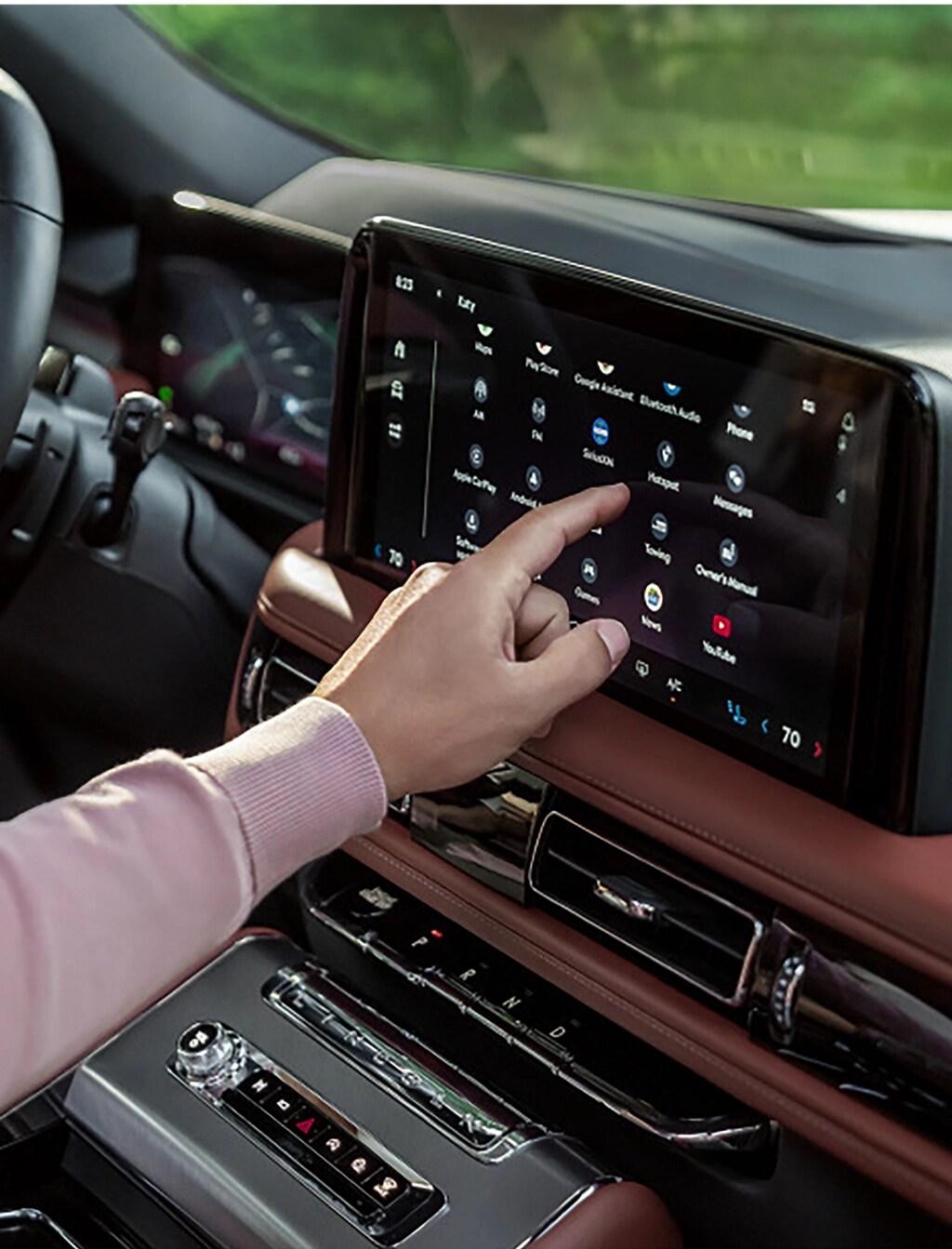 A man using the center touchscreen on his Lincoln Aviator.