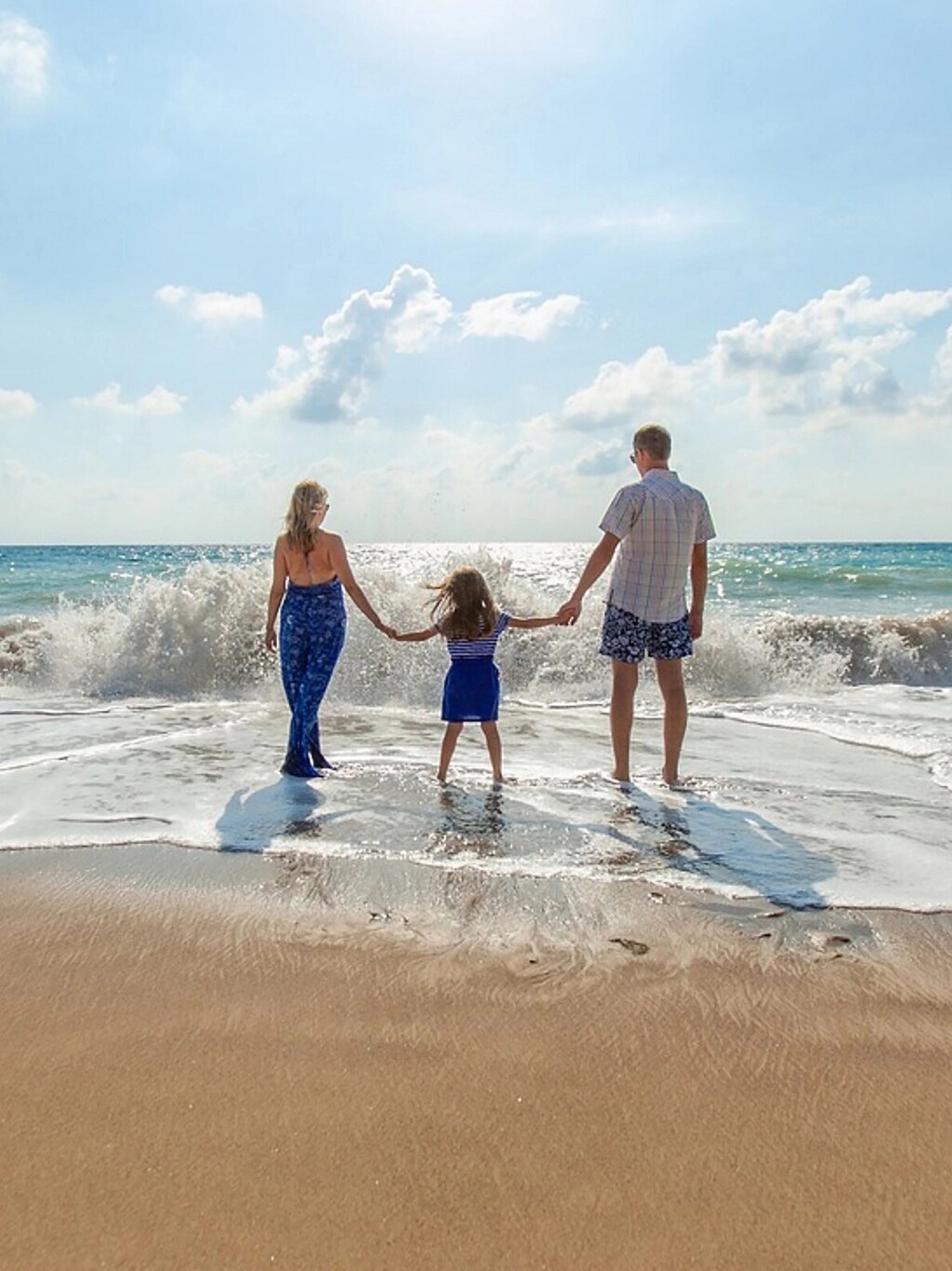 A family standing on the beach.