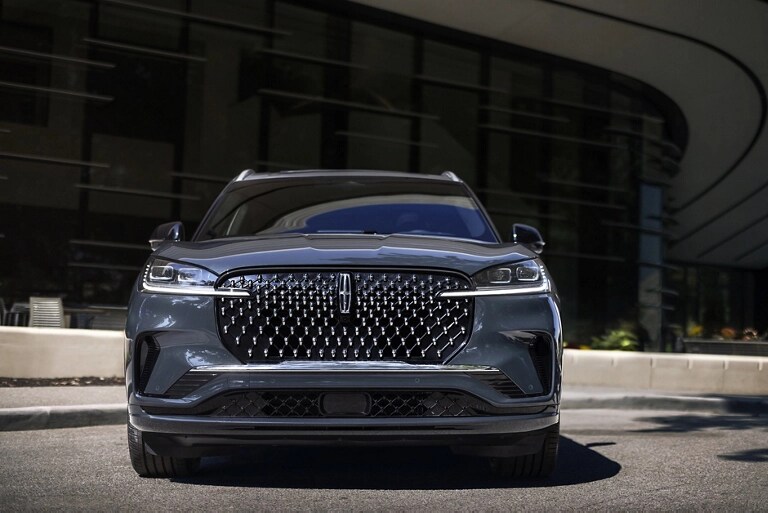 The dazzling grille of a 2026 Lincoln Black Label Aviator® SUV sparkles in the sunlight