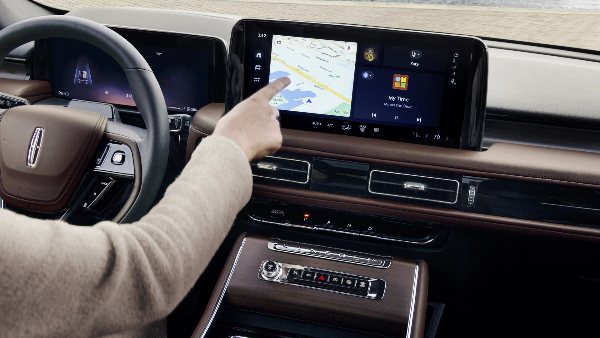 The driver of a 2026 Lincoln Aviator® SUV touches the center touchscreen