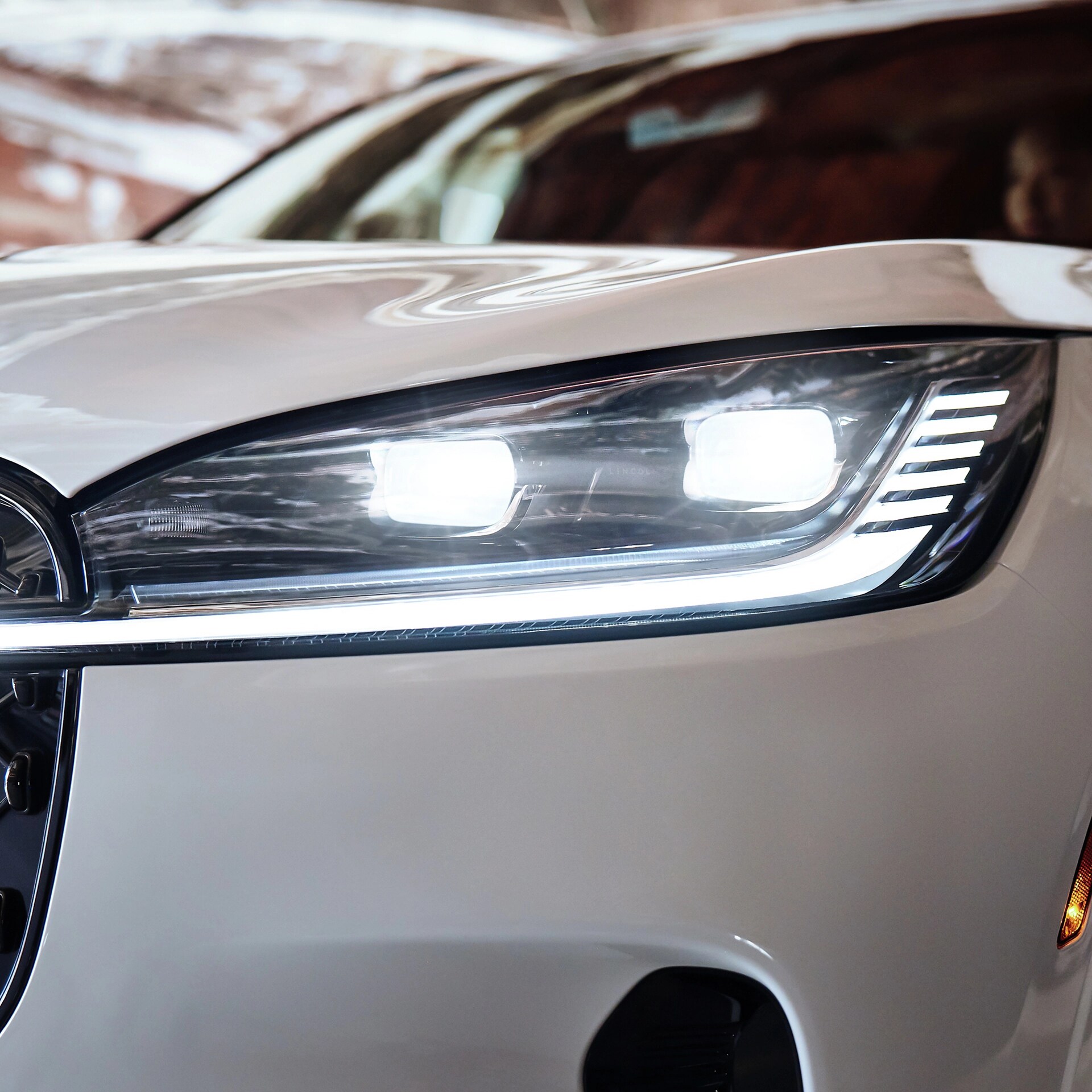 The front left headlamp of a 2026 Lincoln Aviator® SUV is shown