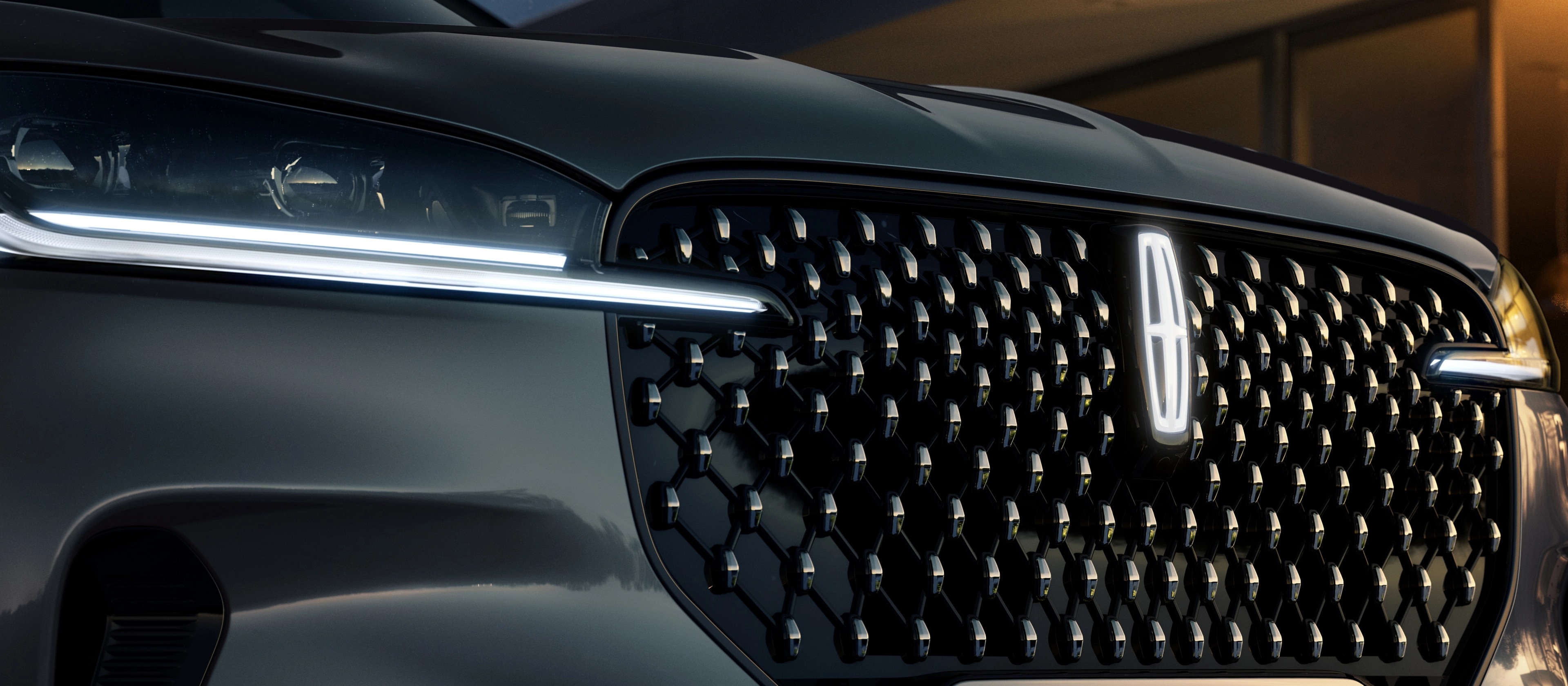 The grille of 2026 Lincoln Black Label Aviator® SUV with glowing Lincoln Star logo in the center