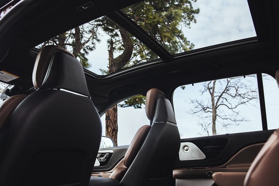 The sky is visible through the Panoramic Vista Roof® of a 2023 Lincoln Aviator®