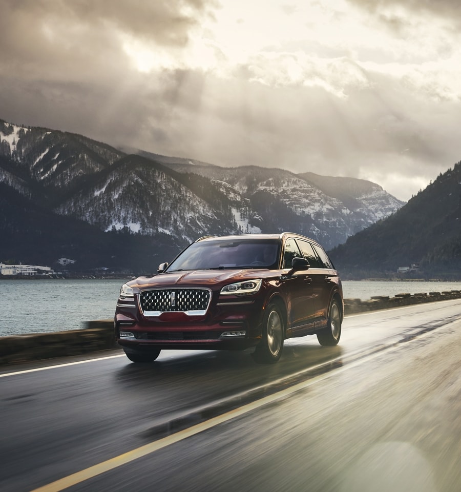 A 2023 Lincoln Aviator® is shown being driven along river valley
