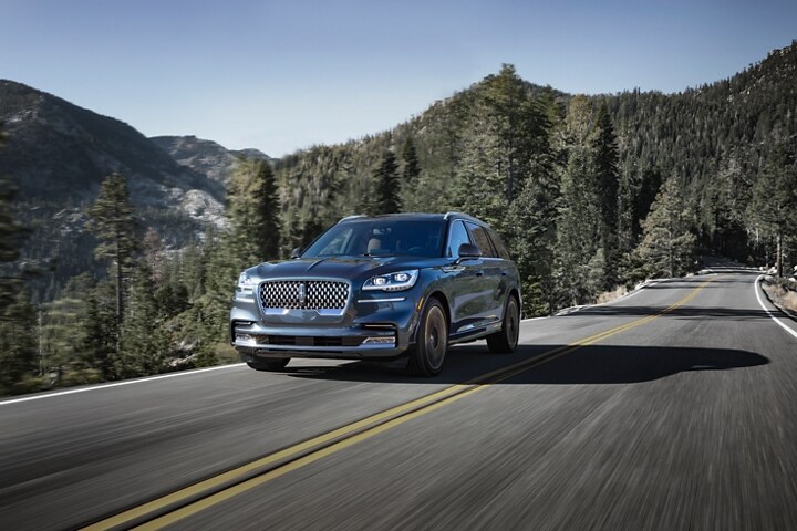Imagen de una Lincoln Aviator® Black Label 2023 con tracción en todas las ruedas circulando por un camino montañoso