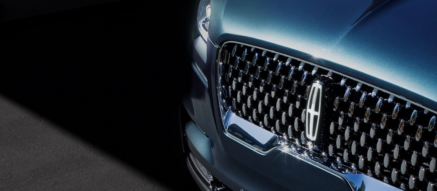 The grille of a Lincoln Black Label vehicle is shown sparkling in the sunlight