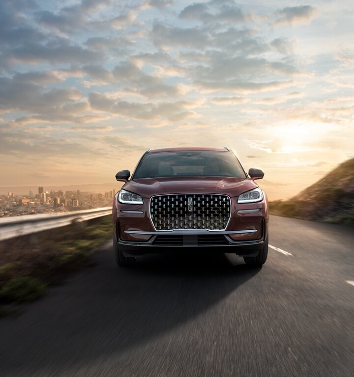 A 2023 Lincoln Corsair® SUV is being driven on a hillside road