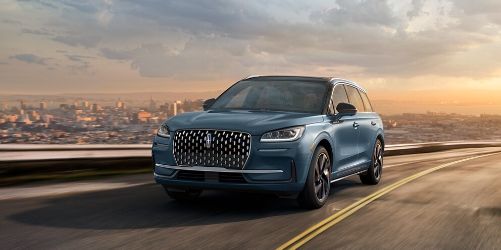 A 2023 Lincoln Corsair® Grand Touring SUV is being driven on a hillside road
