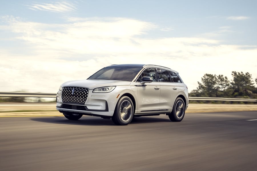 A 2024 Lincoln Corsair® Grand Touring SUV is shown being driven on a rural roadway