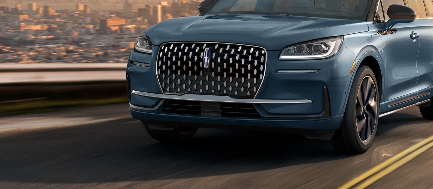 The grille of a 2024 Lincoln Corsair® Grand Touring model sparkles during sunset