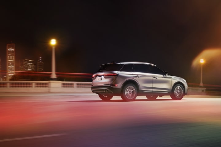 A 2024 Lincoln Corsair® SUV is seen being driven over a city bridge