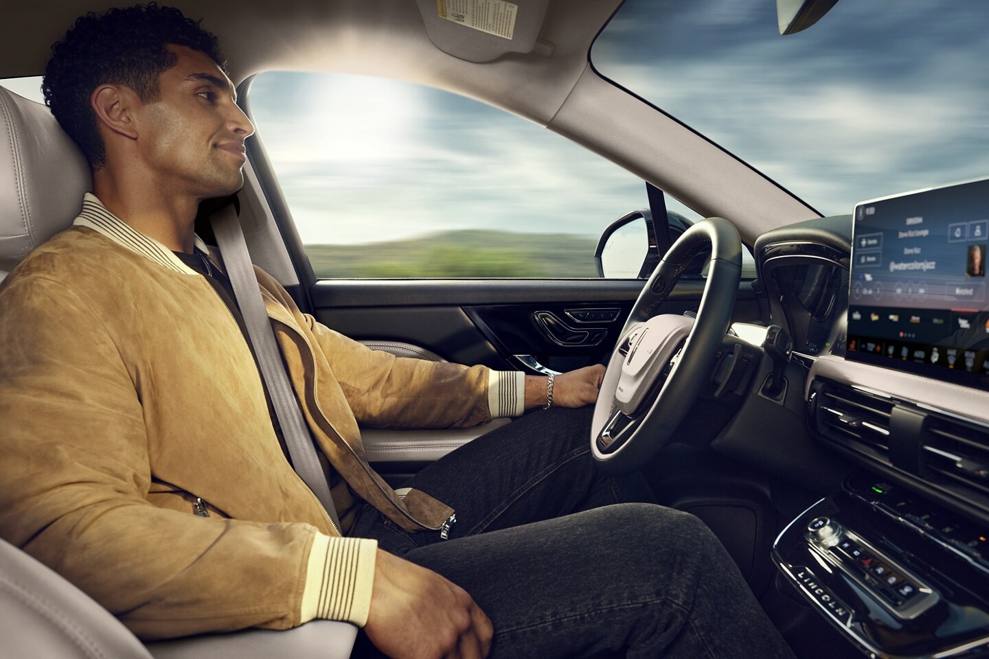 A person is shown sitting in the driver’s seat of a 2024 Lincoln Corsair® SUV driving hands-free using BlueCruise™ 1.2
