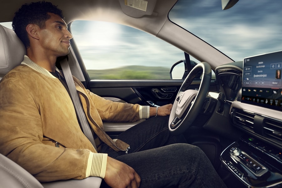A person shown in the driver’s seat of a 2024 Corsair® SUV while using ActiveGlide™ 1.2