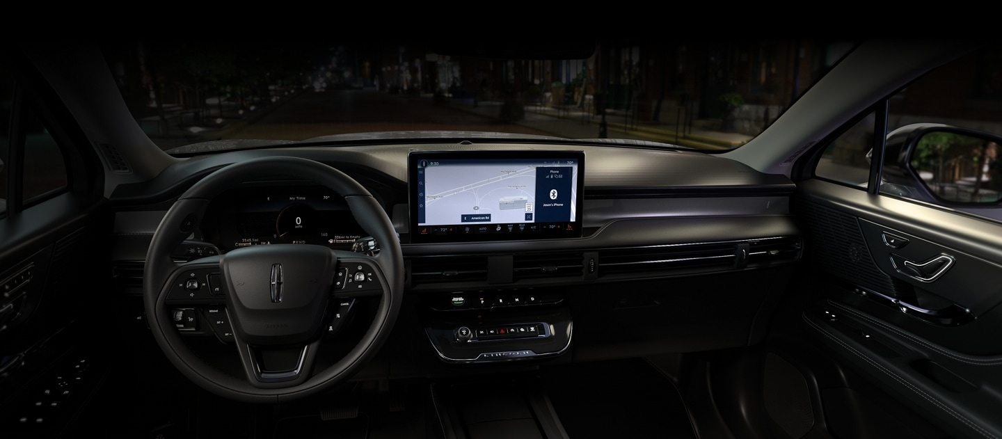 Interior view of the Lincoln Corsair Premiere, highlighting the dashboard, steering wheel, and digital displays.