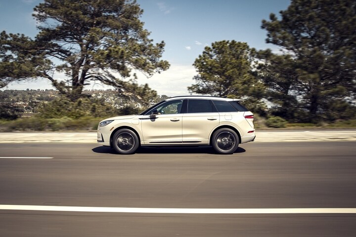 2025 Lincoln Corsair® Grand Touring plug-in hybrid SUV is being driven in the countryside