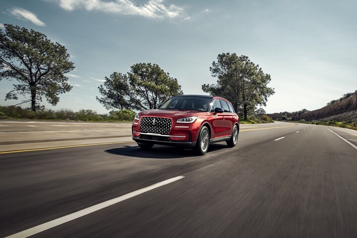 A 2025 Lincoln Corsair® SUV is being driven on a country road