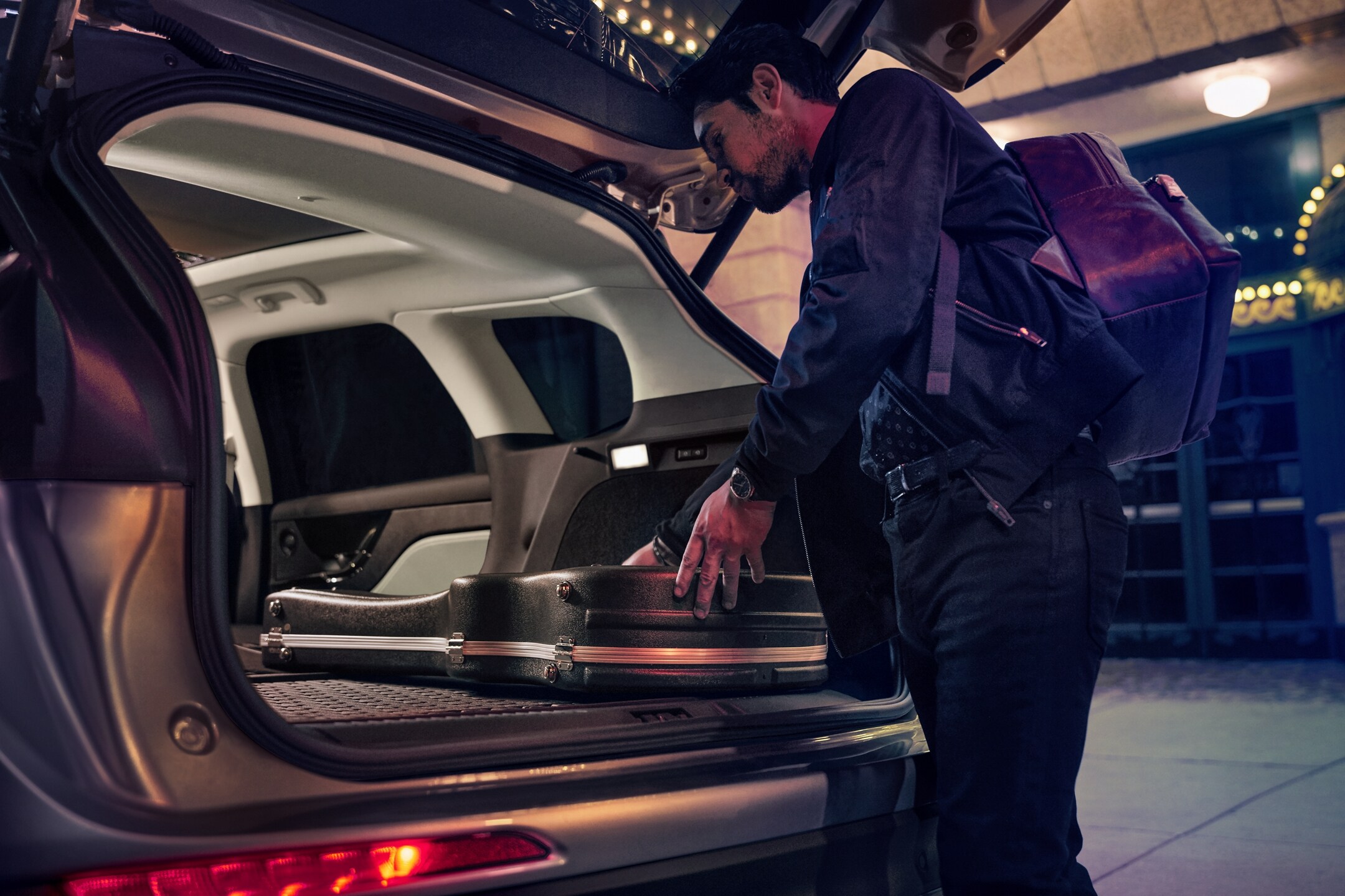 A musician loads musical equipment in the rear cargo area of a 2026 Lincoln Corsair® SUV