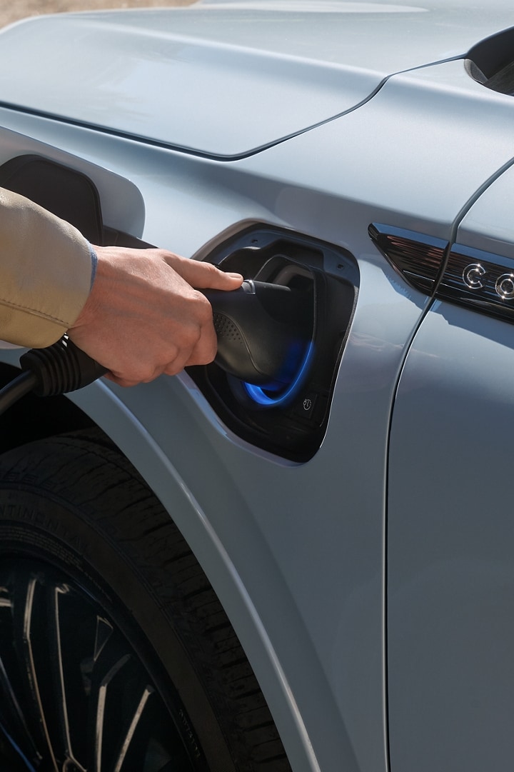 A person charging their Lincoln Corsair.