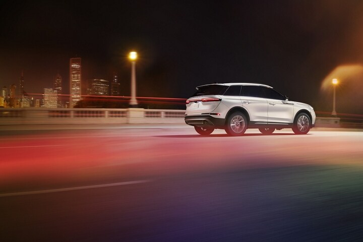 A 2025 Lincoln Corsair® Reserve model is being driven on a highway at night
