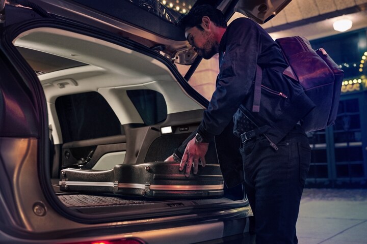 A person loads music equipment into the rear cargo area of a 2026 Lincoln Corsair® SUV