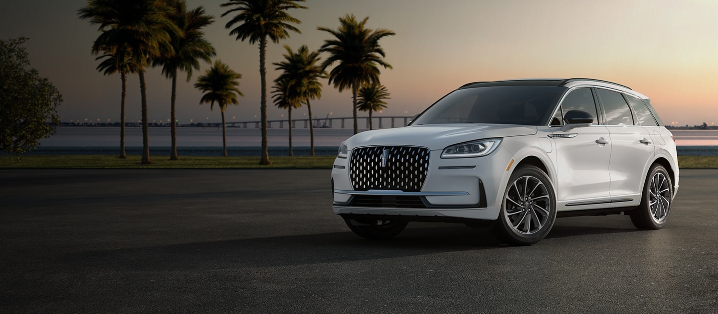 A Lincoln Corsair® Grand Touring set against a sunset and palm trees