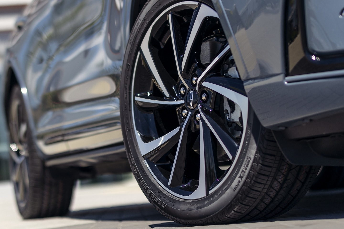 The available 20-inch aluminum wheels with black premium paint are shown on the Grand Touring model