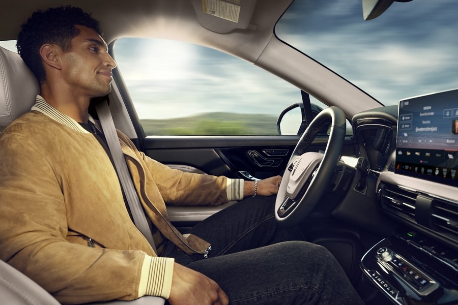 A driver is shown seated in a 2026 Lincoln Corsair® SUV while using hands-free controlled access highway driving