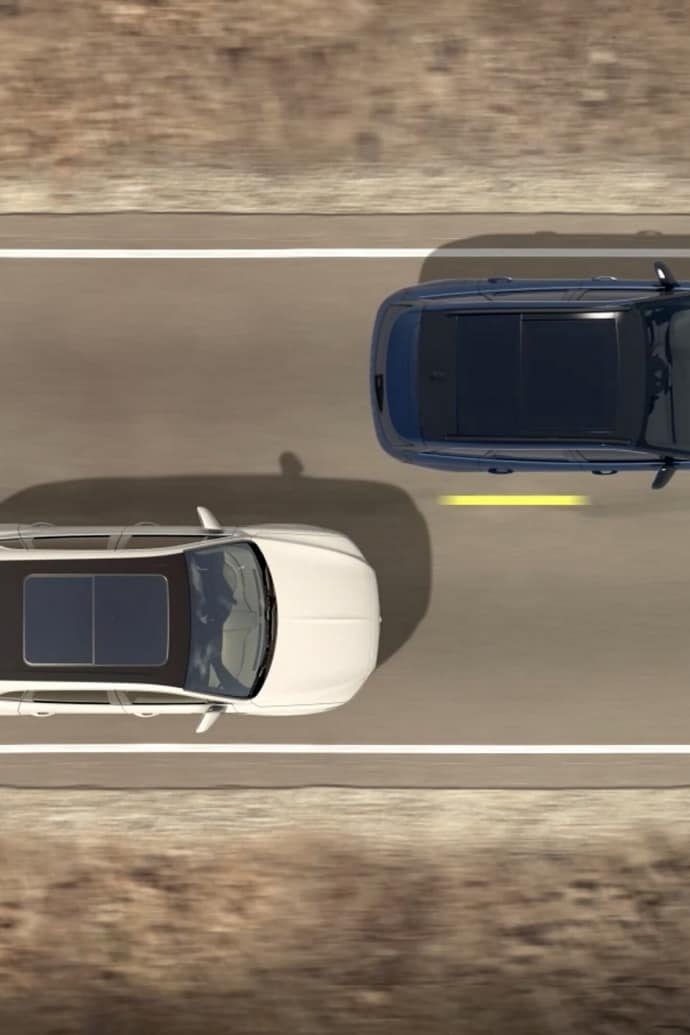 Two vehicles are shown from overhead to demonstrate the Blind-Spot Information System