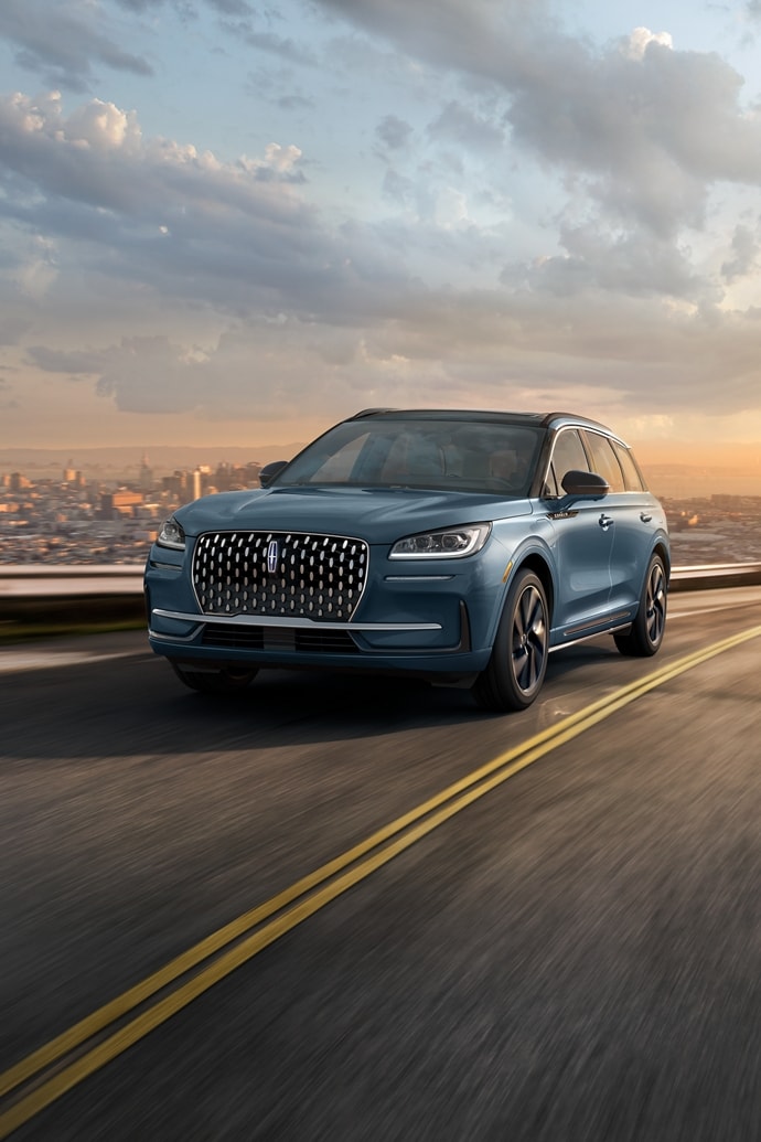 The stylish grille, unique to the 2026 Lincoln Corsair® Grand Touring Plug-in Hybrid, glistens in the sunlight