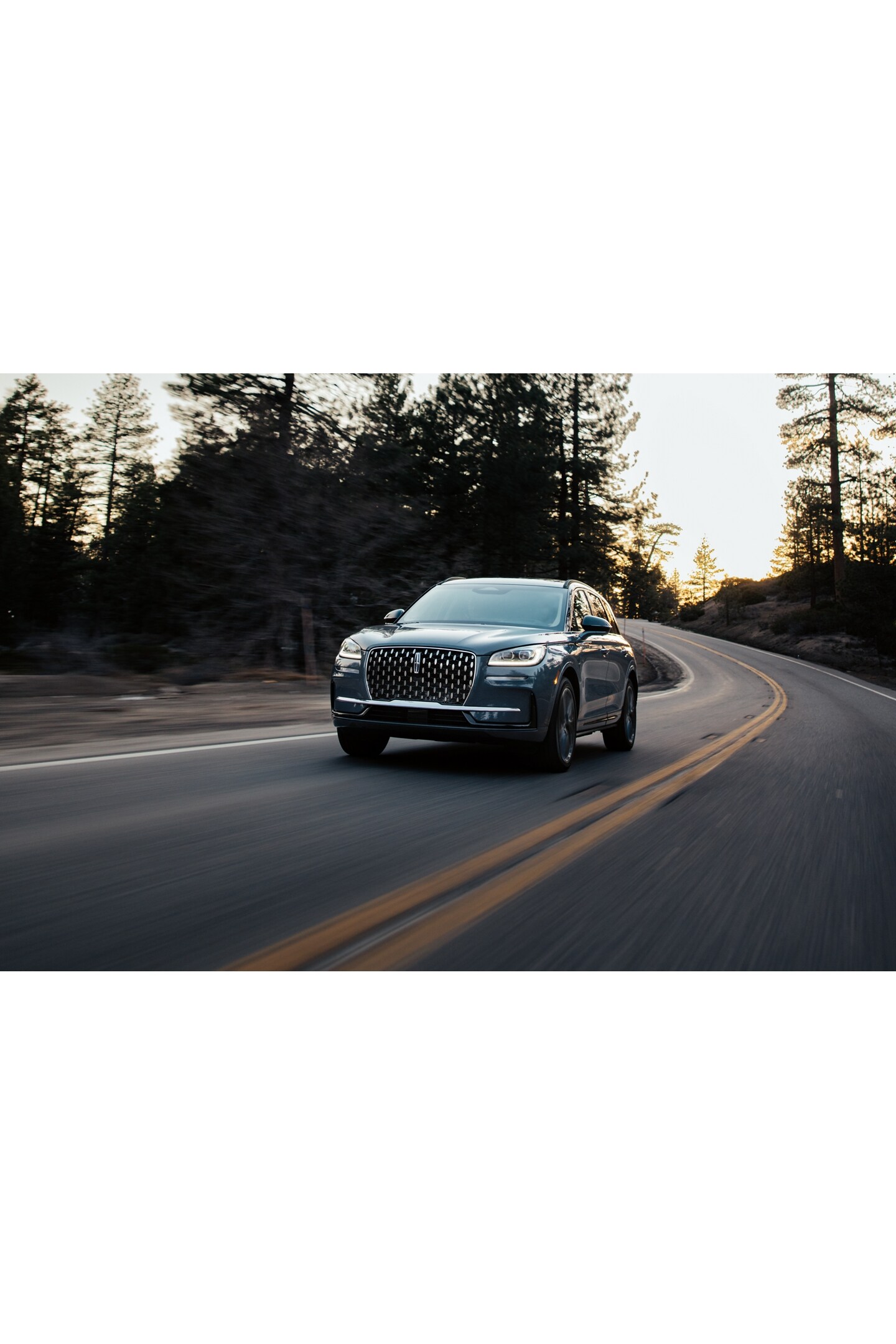 The jewel-like headlamps of a 2026 Lincoln Corsair® SUV emit a concise array of light