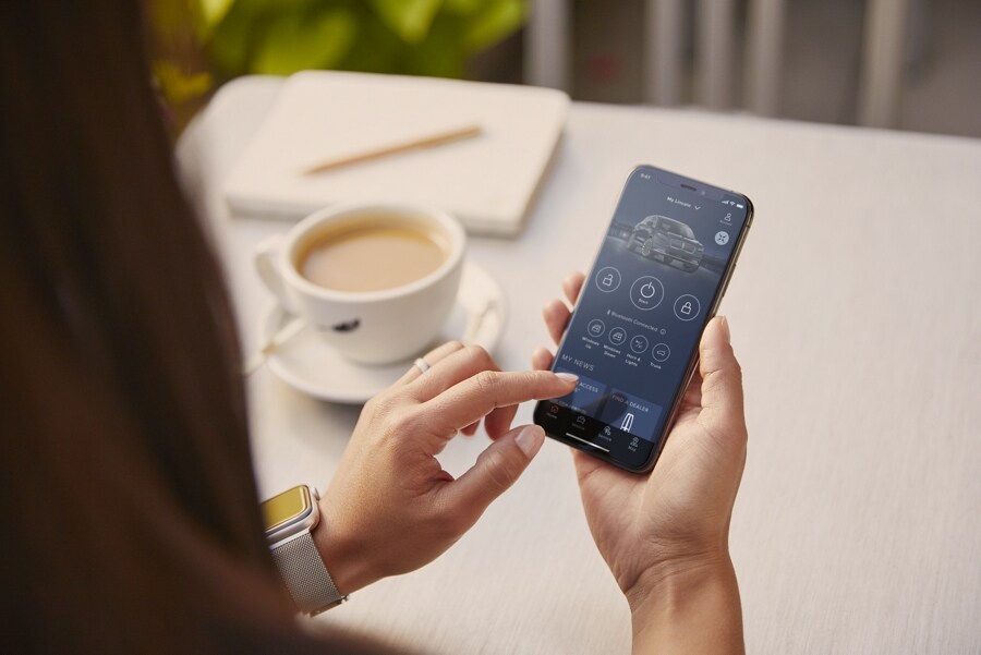 A woman interacts with the Lincoln Way™ App on her smartphone