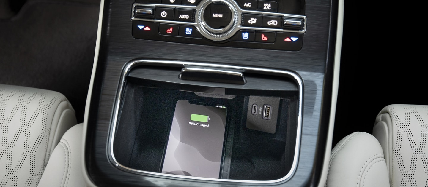 A smartphone is located on the wireless charging pad in a 2023 Lincoln Black Label Nautilus® SUV