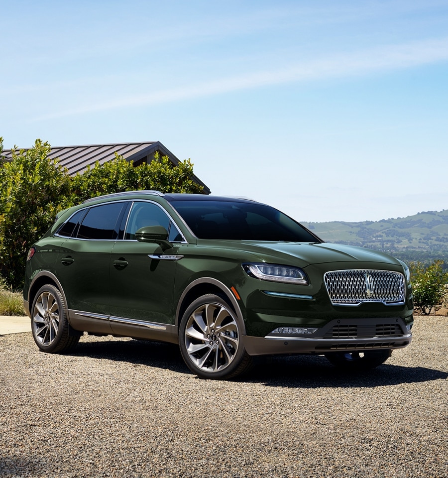 2023 Nautilus shown in Guilded Green in a bucolic landscape