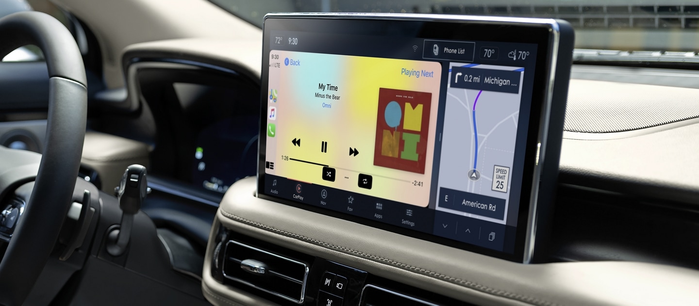 Apple CarPlay® compatibility is being used to play music on the center touchscreen inside a 2023 Lincoln Nautilus® SUV