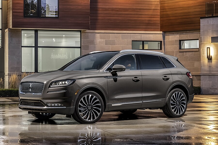 A Lincoln Nautilus Black Label parked outside of a house.