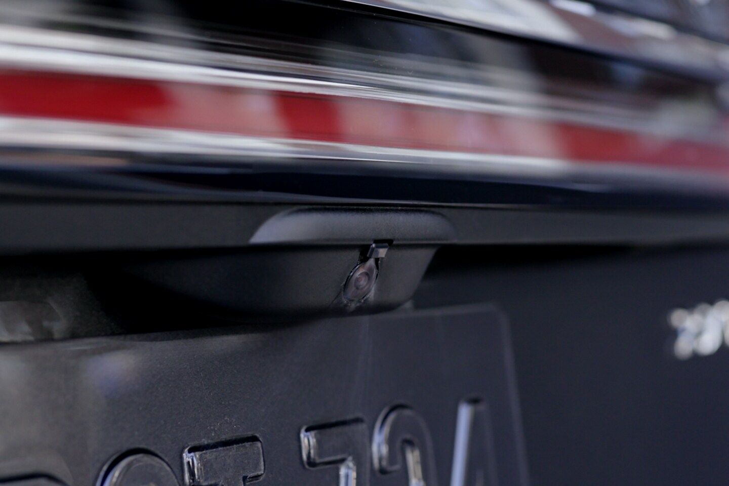The rearview camera on the back of the 2023 Lincoln Nautilus® SUV is being cleaned by the rear camera wash