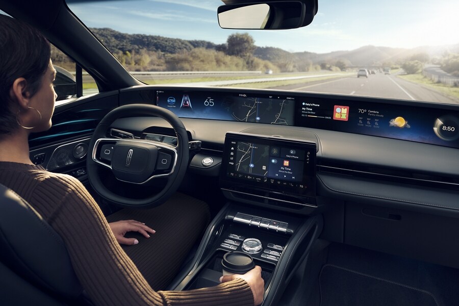 A woman is shown in the driver’s seat of a Lincoln Nautilus® SUV.