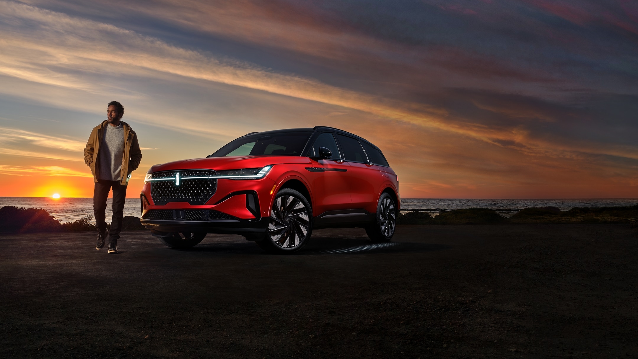 A person is leaving a 2024 Lincoln Nautilus® SUV as the Lincoln Embrace lighting sequence illuminates