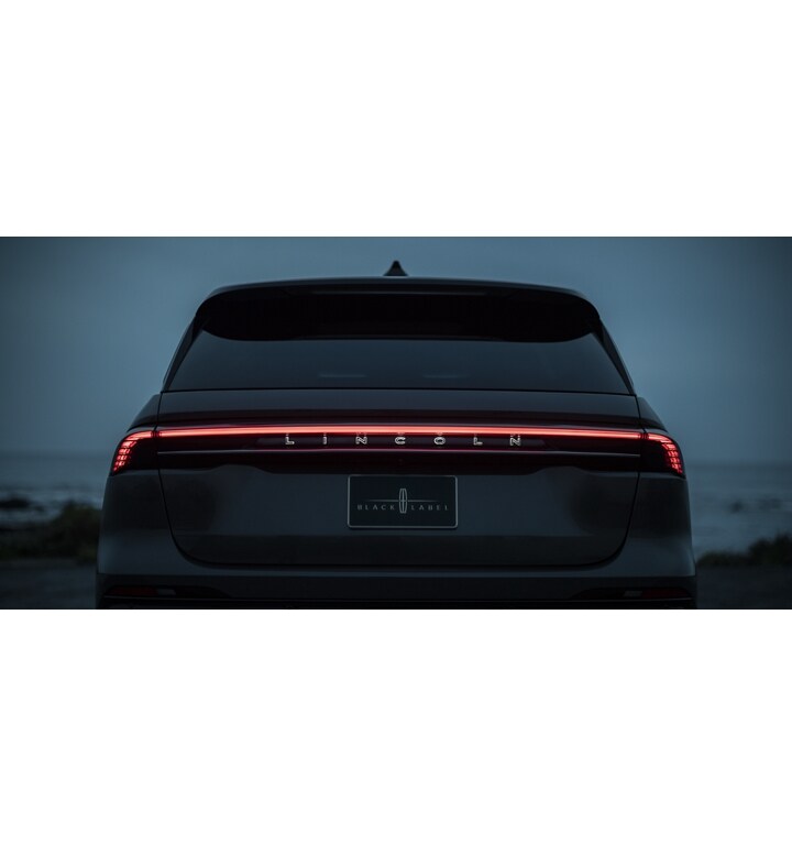 The taillamps of a 2024 Lincoln Black Label Nautilus® SUV are shown illuminating as part of the Lincoln Embrace