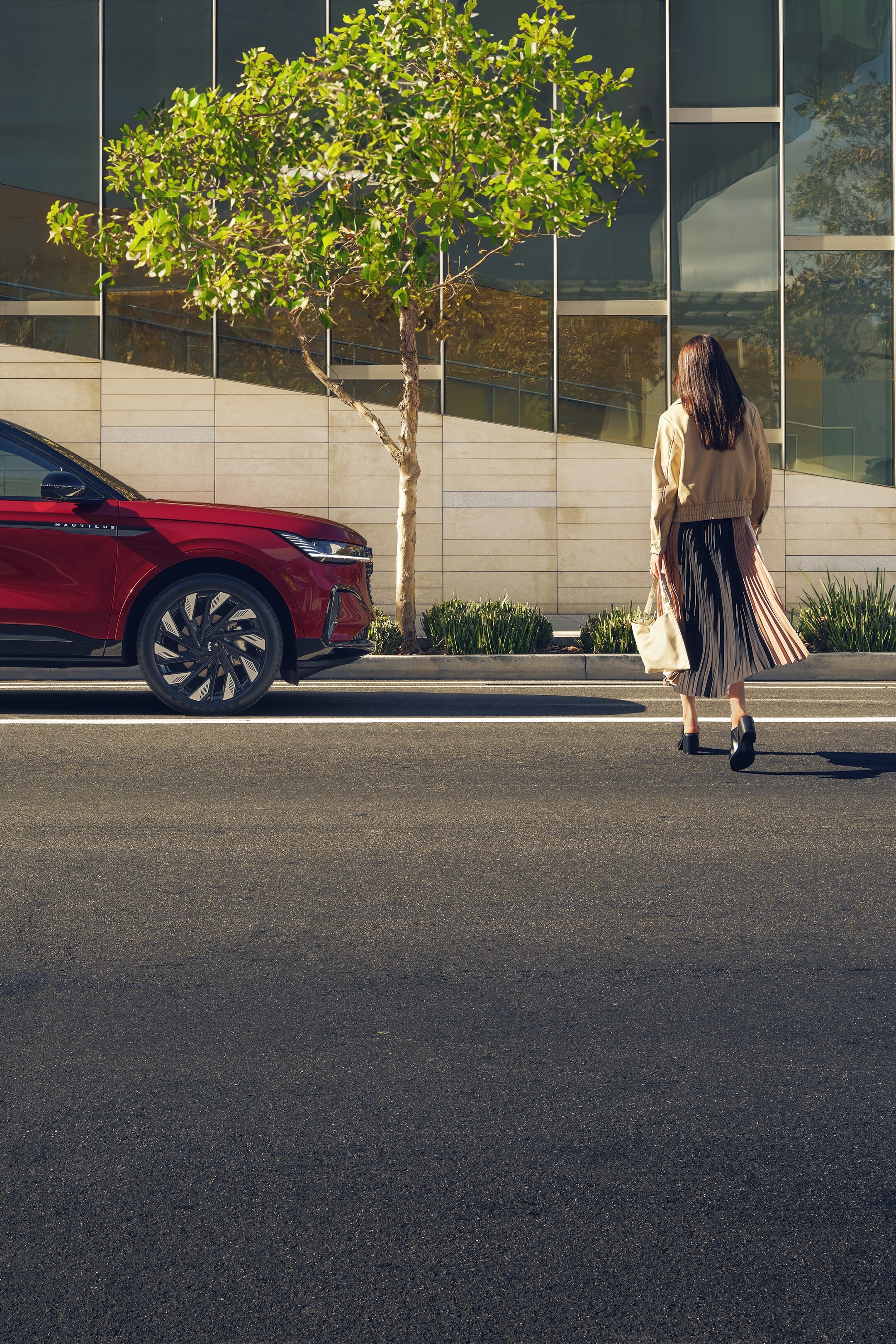 A woman is seen walking toward a 2024 Lincoln Nautilus.